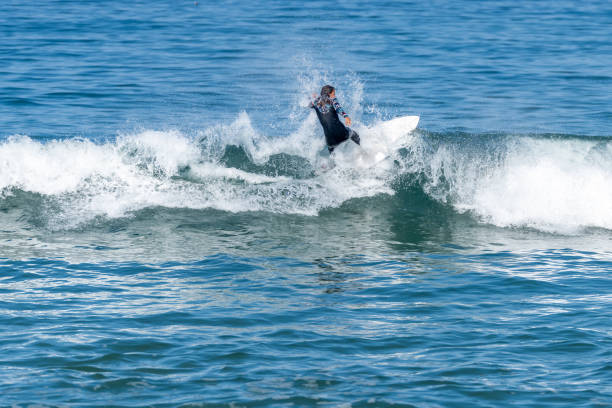 istock Surfer girl riding a wave 1426248125