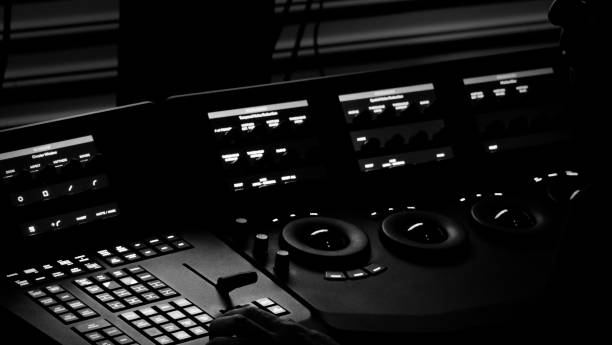 istock Edit video production control panel in studio. Editor editing and grade film in movie post room. Telecine control machine and man hand editing or adjusting color on digital video in post production. 1426249613