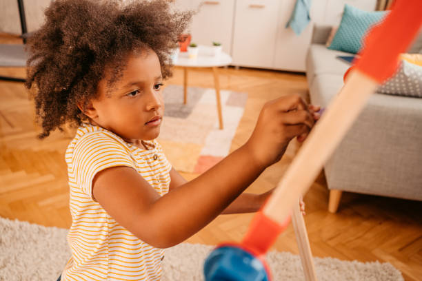 istock Little Girl Playing Alone At Home 1426249722