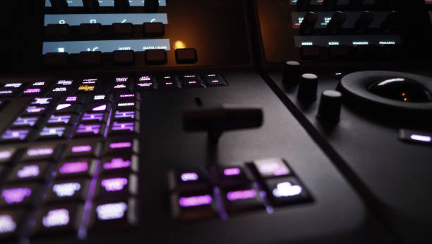 istock Edit video production control panel in studio. Editor editing and grade film in movie post room. Telecine control machine and man hand editing or adjusting color on digital video in post production. 1426249758
