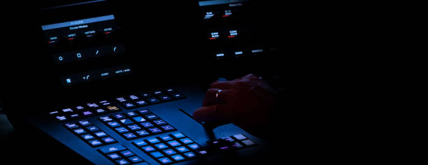 istock Edit video production control panel in studio. Editor editing and grade film in movie post room. Telecine control machine and man hand editing or adjusting color on digital video in post production. 1426249794