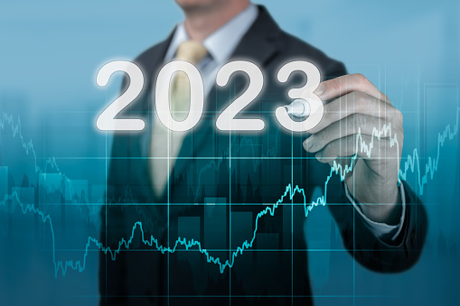 Businessman in suit forecast analysis plan profit chart 2023 year. economic forecasts for 2023. businessman writes 2023 on virtual screen. Businessman in suit forecast analysis plan profit chart