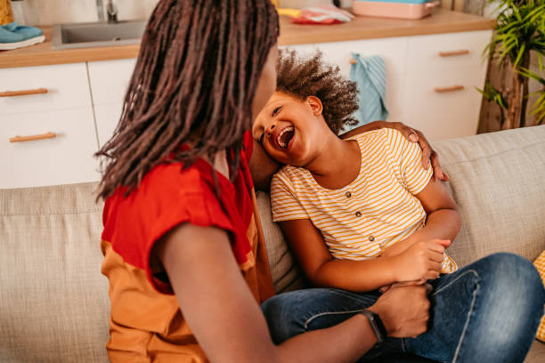 istock Mother And Daughter Laughing Together On The Sofa 1426250283