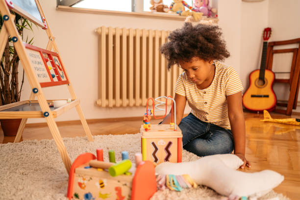 istock Little Girl Playing Alone At Home 1426250723