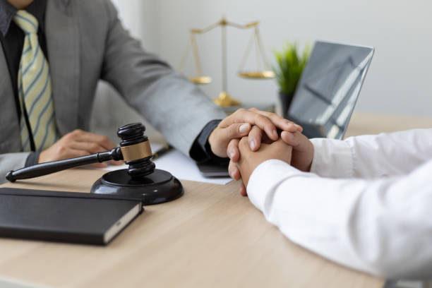 Justice and attorney concept. Lawyer meeting and consoling solution to his client provide legal advice and trust commitment strain serious for problem. stock photo