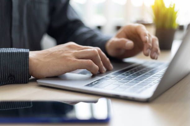 istock Close-up of man hands working on laptop keyboard. 1426252408
