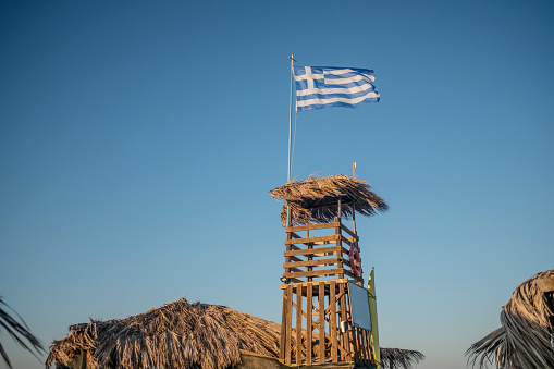 Greek flag in the wind in Tigaki village of Kos Island.