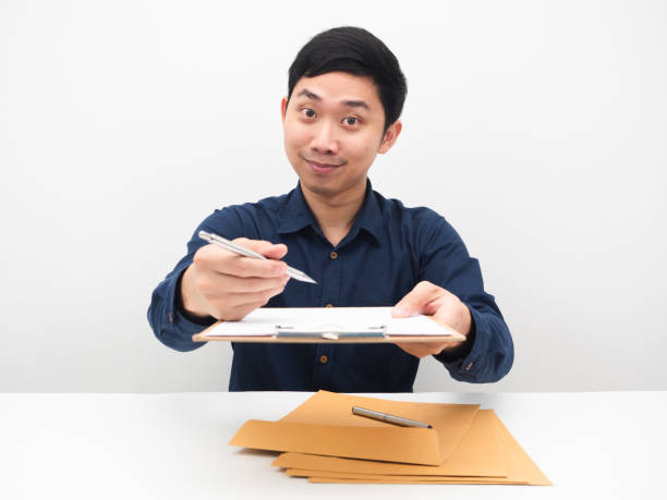 Businessman give pen and document board to you choose you concept white background Businessman give pen and document board to you choose you concept white background man writing on white board stock pictures, royalty-free photos & images