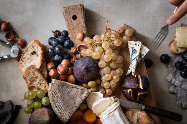 istock Rustic French Autumnal Cheese Board with hand 1426257801