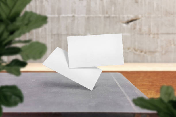 istock Clean minimal business card mockup floating on top table with plant background 1426258727