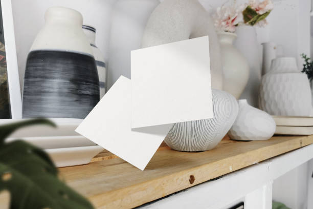 istock Clean minimal square flyer mockup floating on vase shelf with plant 1426258927