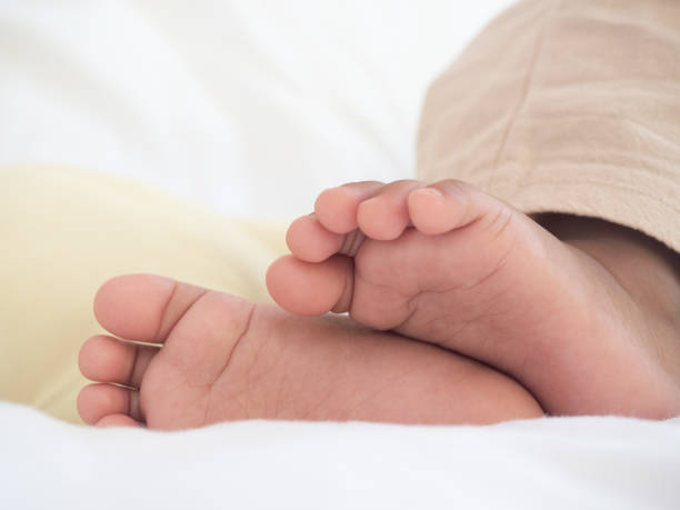 istock Close up baby feet on the bed 1426259781