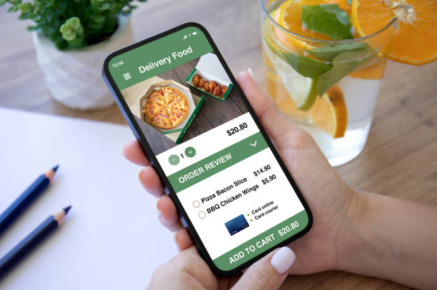 istock female hands holding phone with food delivery application on screen 1426259891