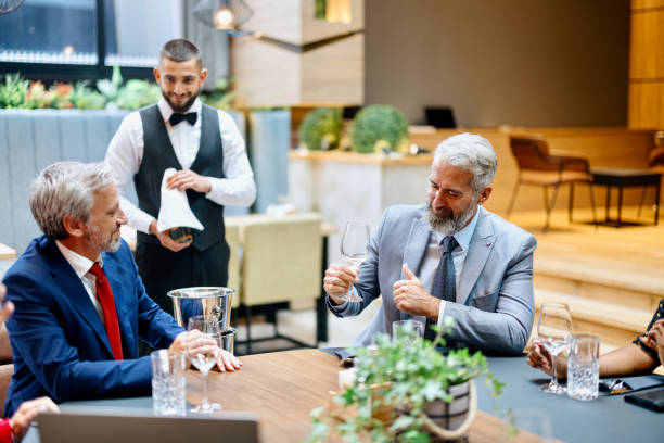 istock Businessman smelling and tasting wine in a restaurant 1426261244
