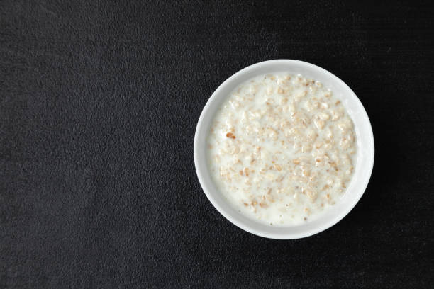 istock Oatmeal porridge in white bowl on a dark background 1426264364