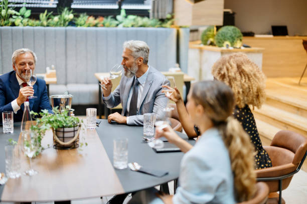 istock Business people toasting with wine while having lunch in a restaurant 1426268067
