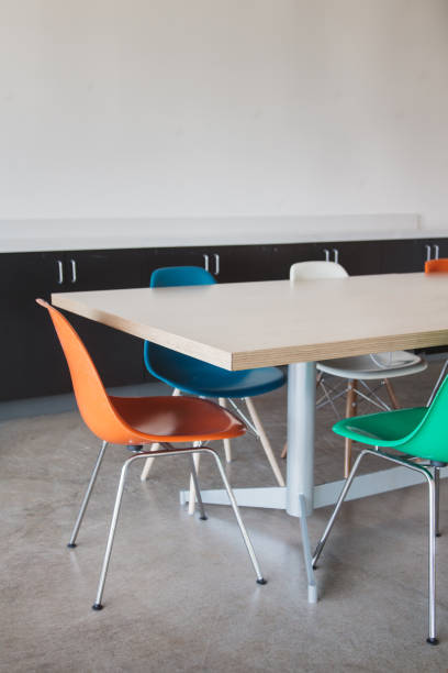 istock Colorful Eames Molded Plastic Chairs set around business conference meeting room table 1426268713