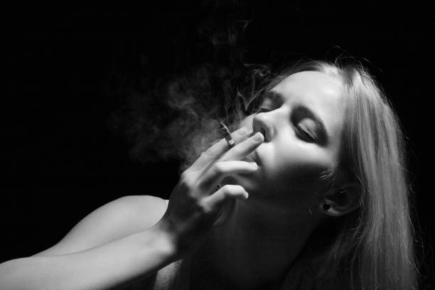 istock woman smoking cigarette 1426269058