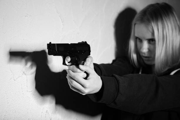 istock girl with gun 1426269320