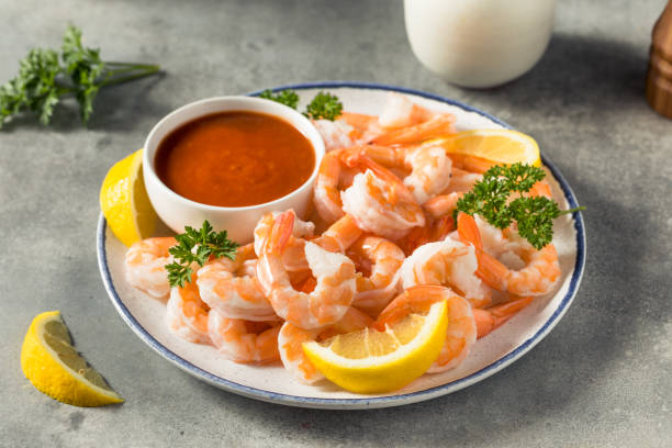 Homemade Cold Shrimp Cocktail Homemade Cold Shrimp Cocktail with Lemon and Sauce shrimp cocktail stock pictures, royalty-free photos & images