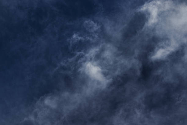 istock wisps of white cirrus clouds swirling under a dark sky, blown by the winds. 1426281014