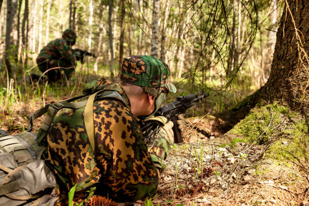 russische soldaten mann gekleidet militärische tarnuniform mit waffe in wald in der natur hintergrund, rückansicht. männlicher grenzschutz an der landesgrenze mit autogun im krieg. textraum kopieren - airsoft stock-fotos und bilder