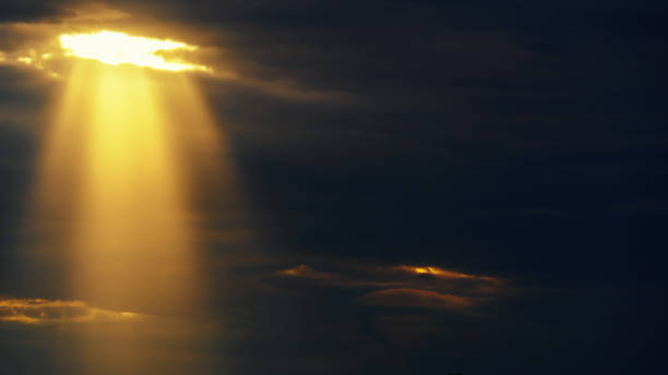 istock bright sun ray through dark dramatic sky with storm clouds, extreme weather sky for abstract background 1426282504