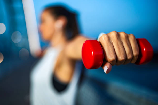 istock Young Woman Exercise Outdoors With Weights Focus on Dumbbell 1426286813