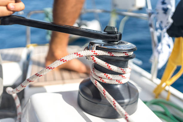 istock Hand cranks rope in on sailboat 1426287223