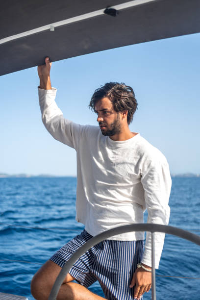 istock Young man relaxes on sailboat at sea 1426287238
