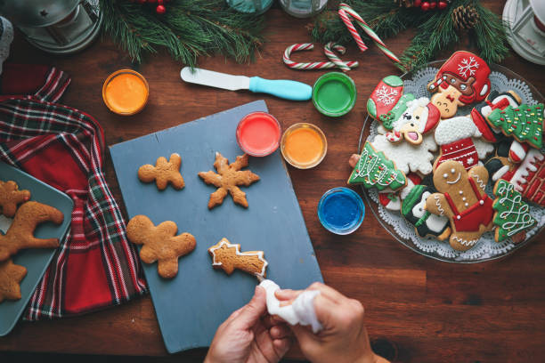 istock Decorating Gingerbread Christmas Cookies in Christmas Home Atmosphere 1426294997