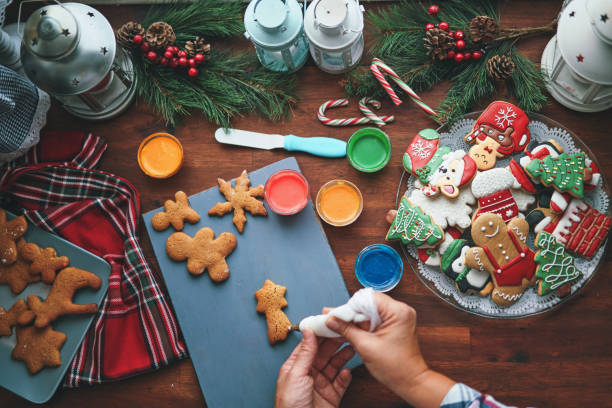 istock Decorating Gingerbread Christmas Cookies in Christmas Home Atmosphere 1426295004