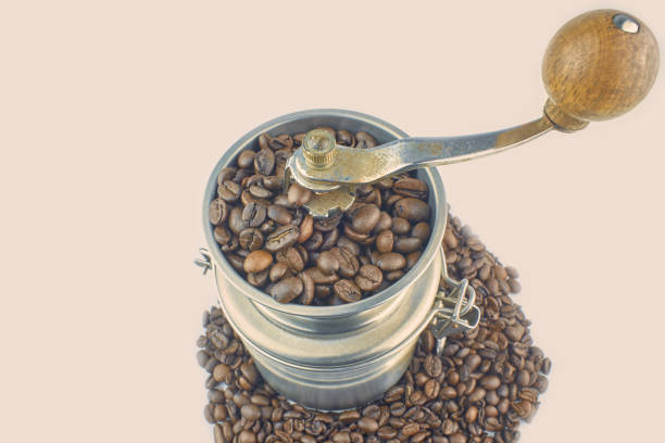 Old Coffee Grinder with Coffee beans, isolated on white