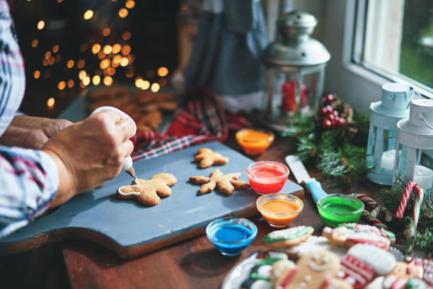 istock Decorating Gingerbread Christmas Cookies in Christmas Home Atmosphere 1426295016