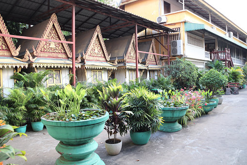 Decorative pavilion and tropical plants in clay pots, garden of Royal Palace complex, Phnom Penh, Cambodia