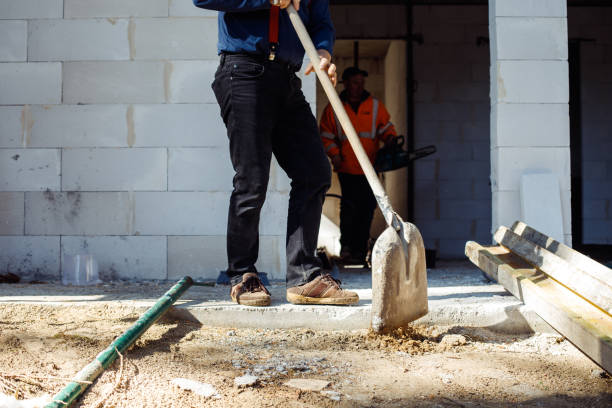 istock Cropped worker builders, men in uniform and caps, labors, wetbacks preparing foundation floor for building process, base 1426302774