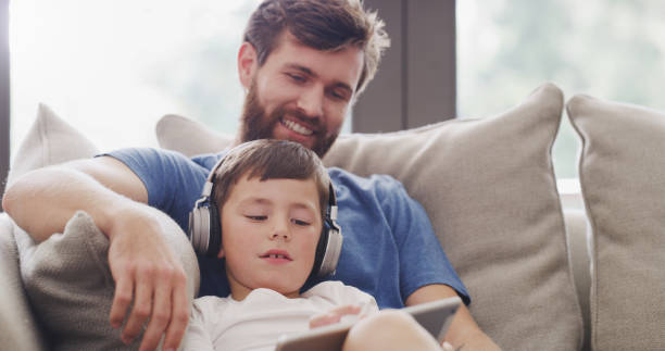 istock Digital tablet kid, father and playing games, watching cartoons and internet development online at home. Curious boy child, dad and learning in technology, fun modern apps and educational connection 1426303187