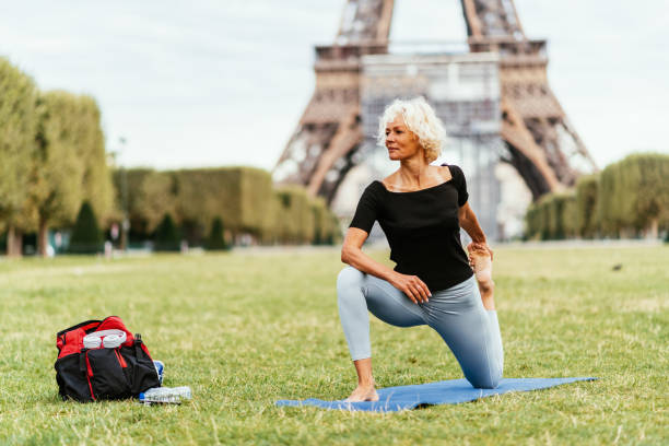 istock Mature woman practicing yoga and stretching her muscles after training 1426303967