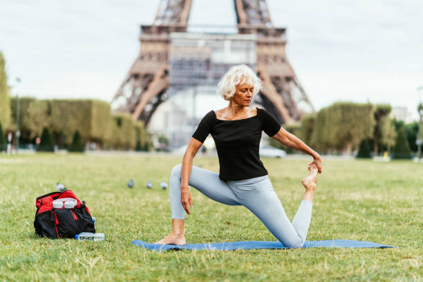 istock Mature woman practicing yoga and stretching her muscles after training 1426304057