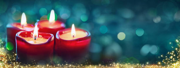 istock Four Advent candles with christmas lights isolated 1426304702