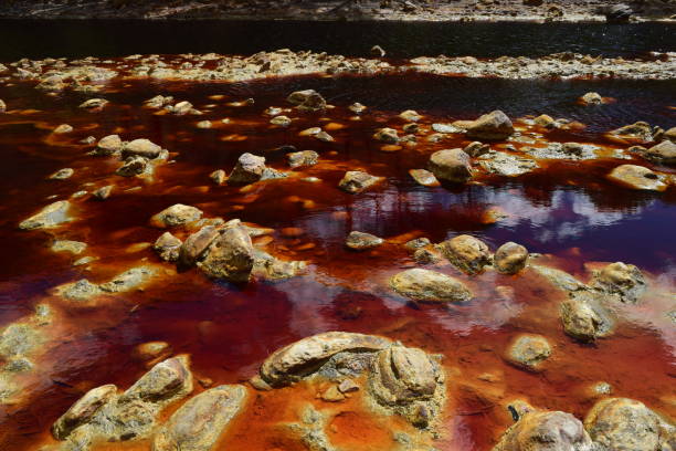 istock Landscape of reddish river with polluted water 1426306615