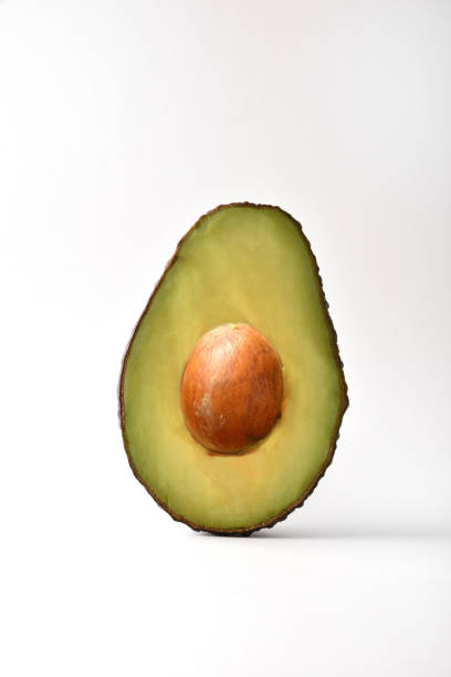istock Half avocado detail on white background 1426307975