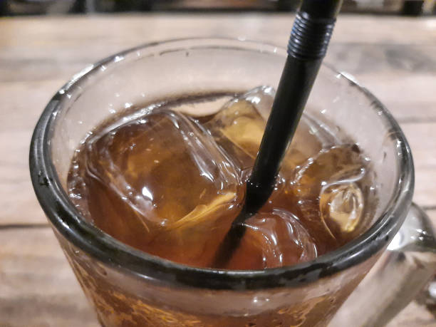 istock iced tea in the glass with black plastic straw 1426308128