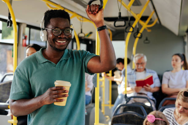 istock Black man having coffee to go in bus 1426308587