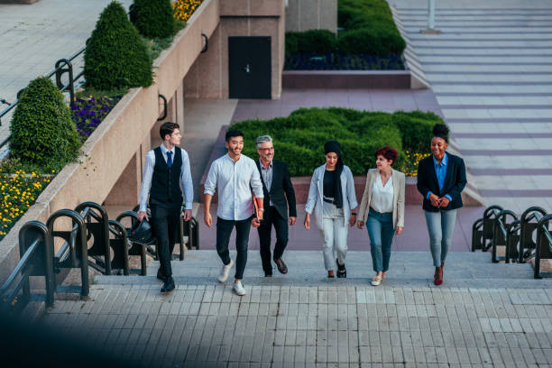 istock Group of versatile businesspeople on street 1426308732