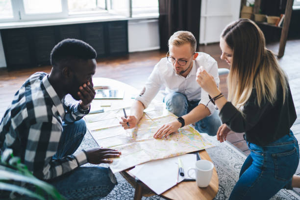 istock Group of diverse colleagues studying map together 1426310633