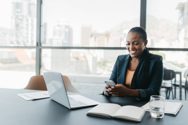 business girl with phone typing during work break replying to email, sms message or networking via social media app. communication, text conversation and black woman using smartphone for web search - ceo corporate business indoors lifestyles imagens e fotografias de stock