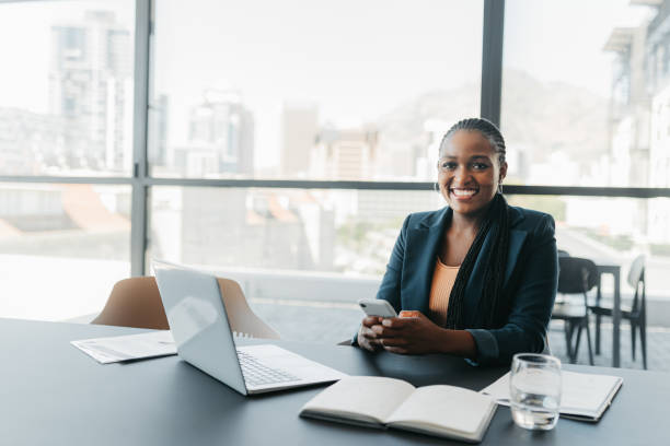 istock Business, black woman with a phone using technology in a office ready to start work. Happy, smile and proud female corporate worker working on a mobile and computer for career and job success growth 1426312067