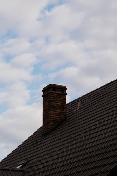 istock Old red brick chimney on a background of the cloudy sky 1426314595