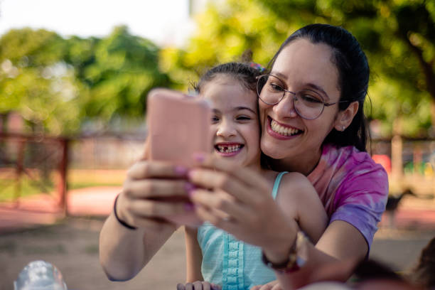 istock Mother and daughter connected to smartphone. 1426317071